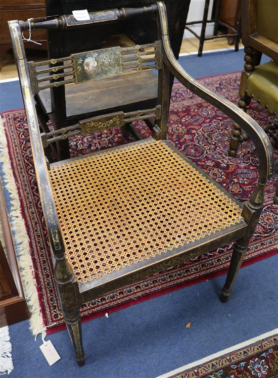 A Regency parcel gilt and ebonised elbow chair, with caned seat